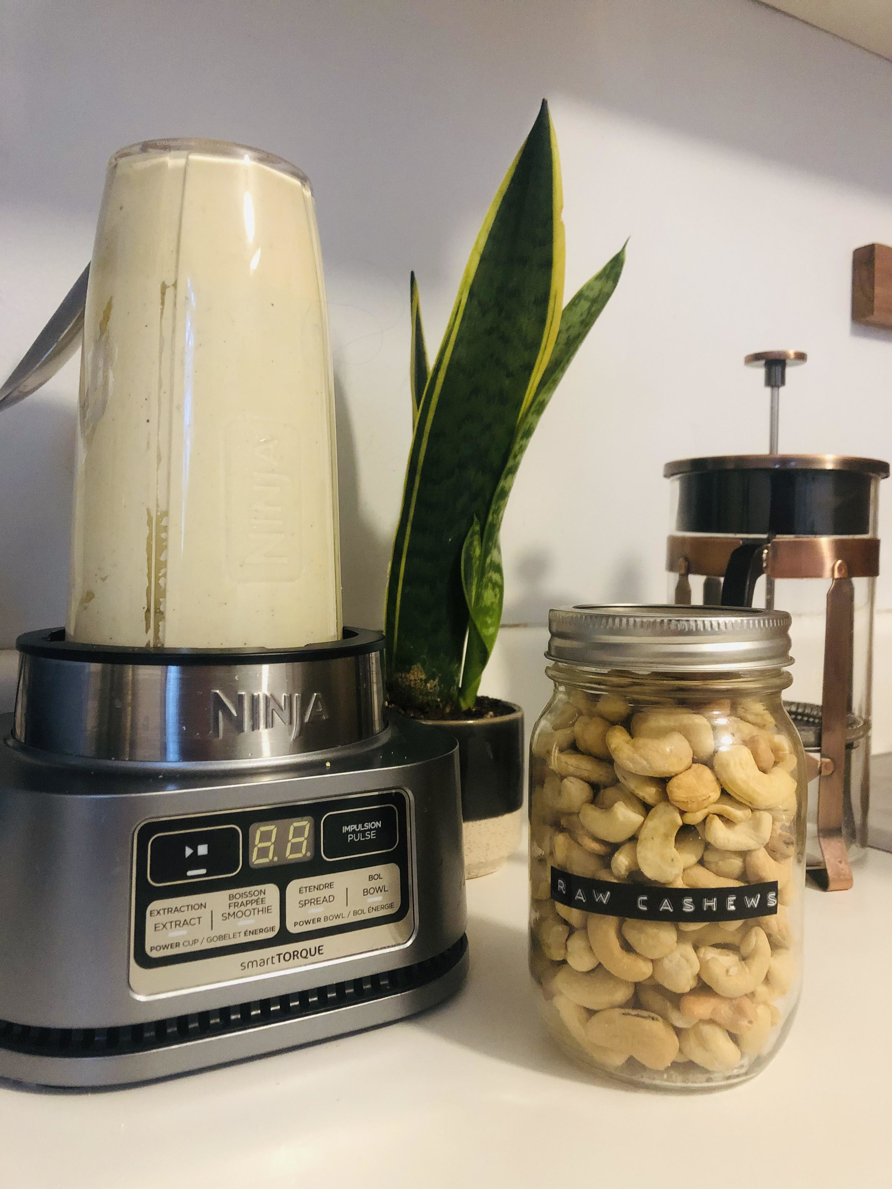 The blender next to a jar of cashews