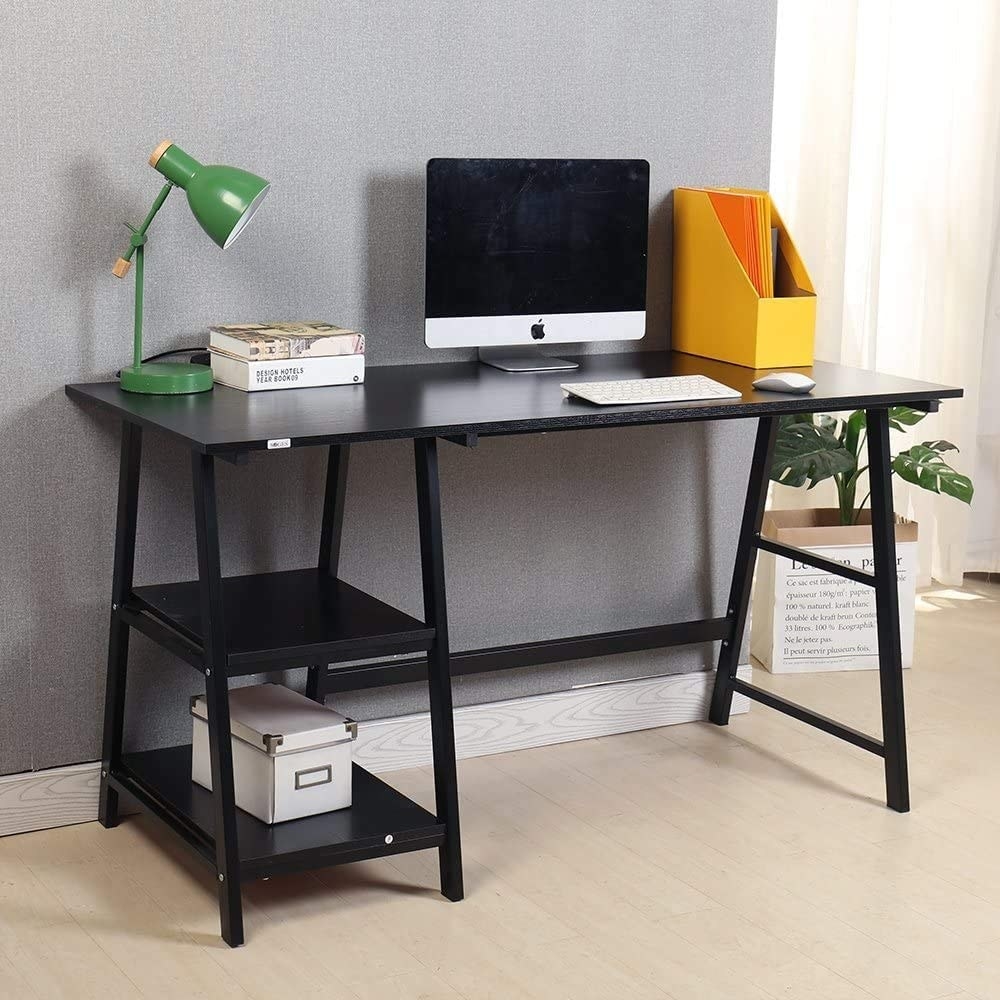 A small wooden desk with a laptop and lamp on the top There are two built-in shelves underneath with a small box on one