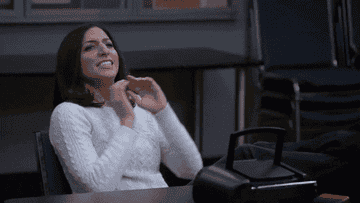 A gif of Gina Linetti from Brooklyn 99 pumping her arms and mouthing &quot;yaass&quot; 