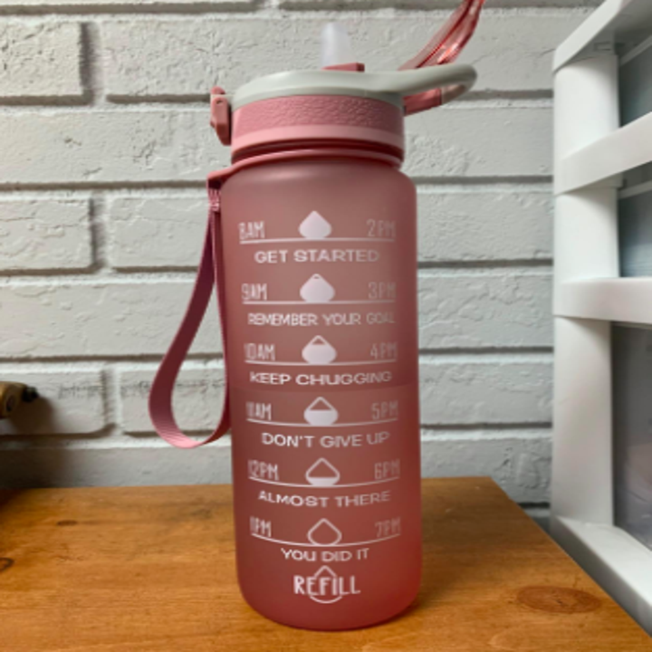 reviewer pic of pink water bottle with text on side encouraging you to drink more water