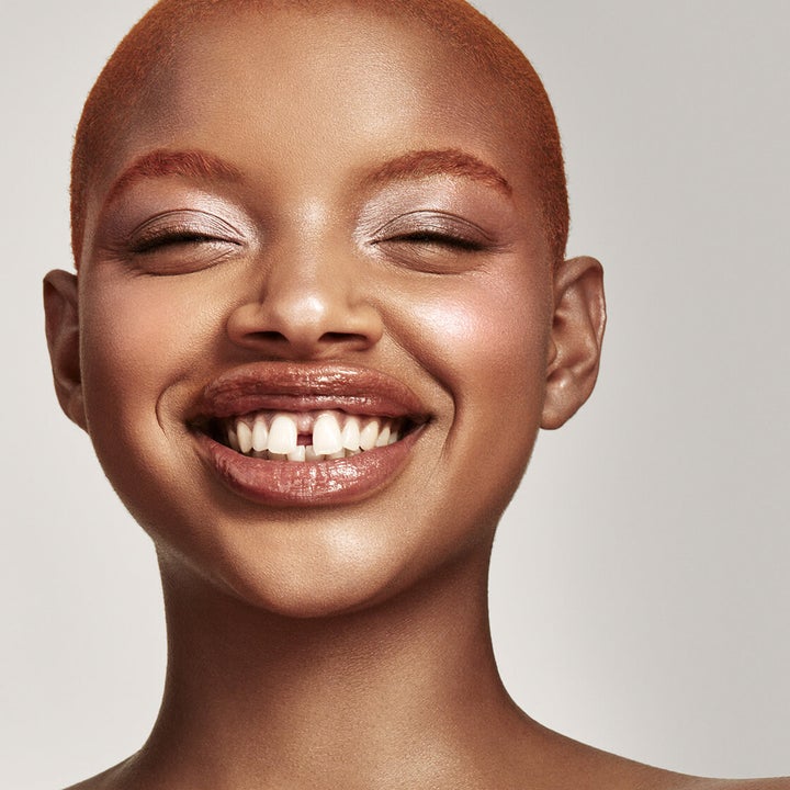 a Black model with the killawatt freestyle highlighter duo in LIGHTNING DUST / FIRE CRYSTAL on their face