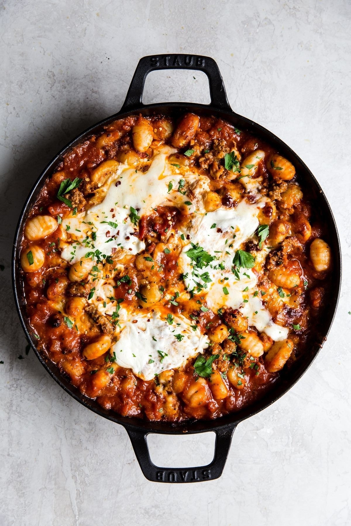 A skillet of cheesy baked gnocchi.