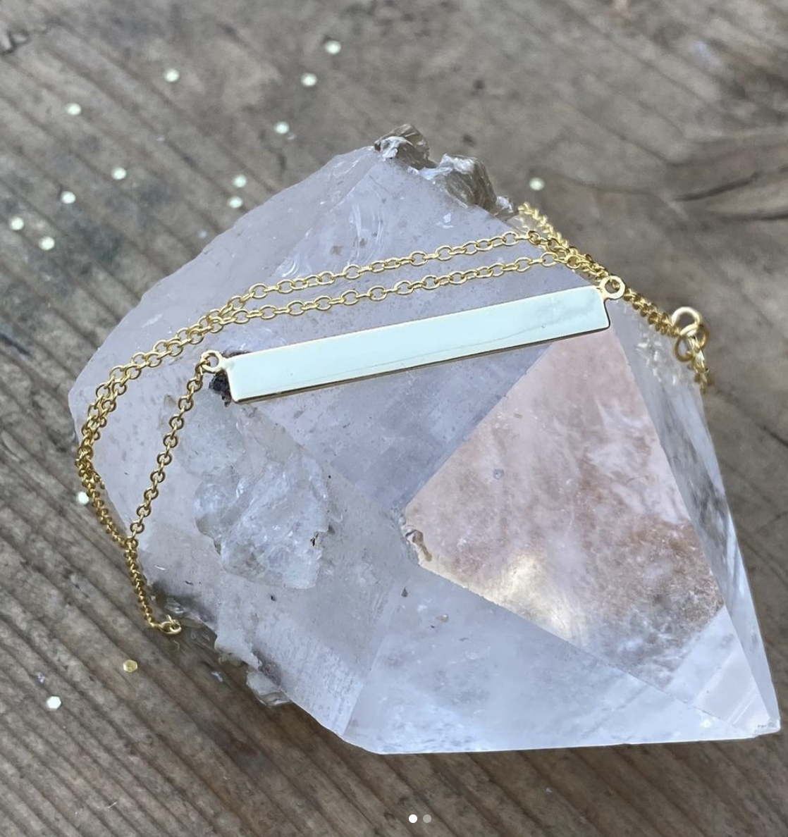 A plate necklace on a quartz stone