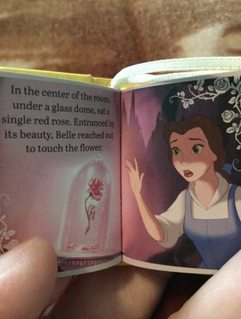 The book open to a page with belle on it 
