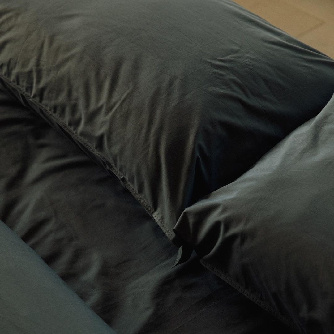 Dark sheets on a bed
