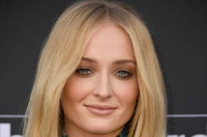 Sophie Turner posing at a press event