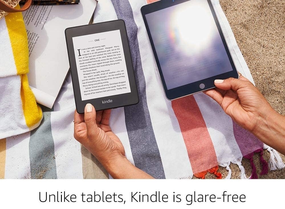 A person holding up the Kindle paperwhite next to a glaring tablet