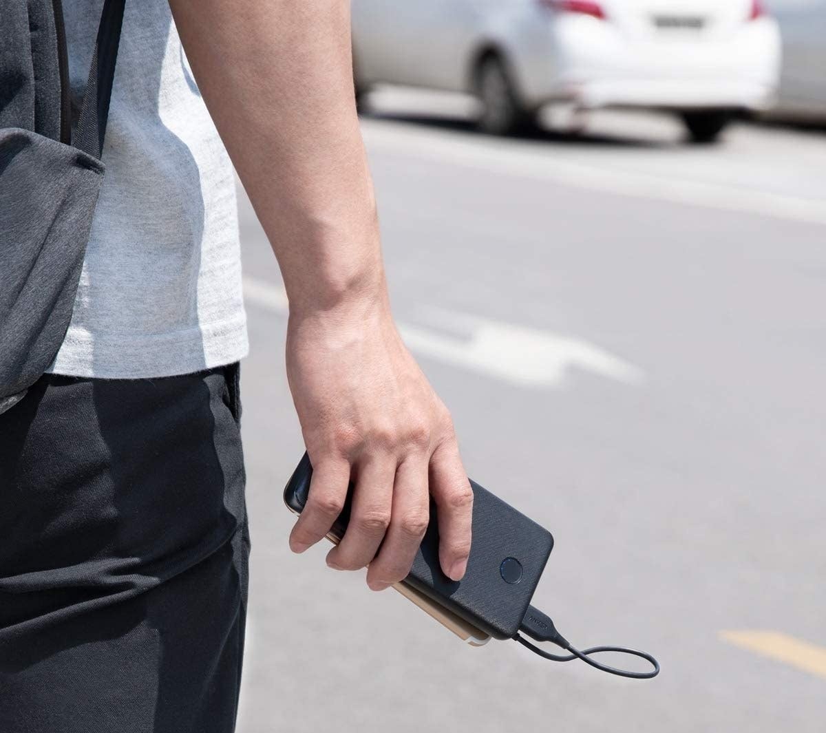 person holding the charger plugged into their phone