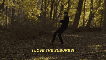 A man walking through a big yard saying &quot;i love the suburbs&quot;