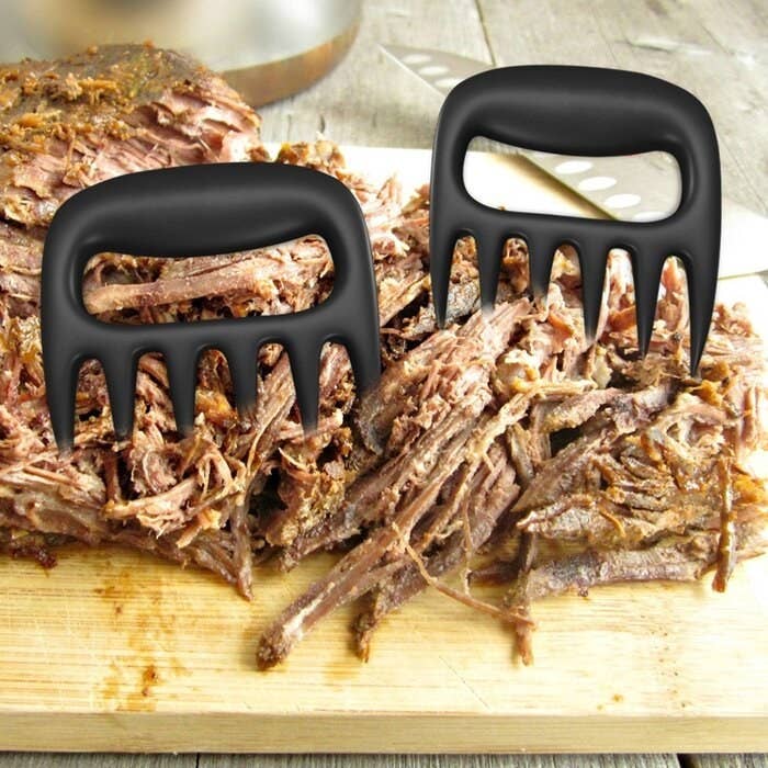 Meat shredding claws on top of shredded meat