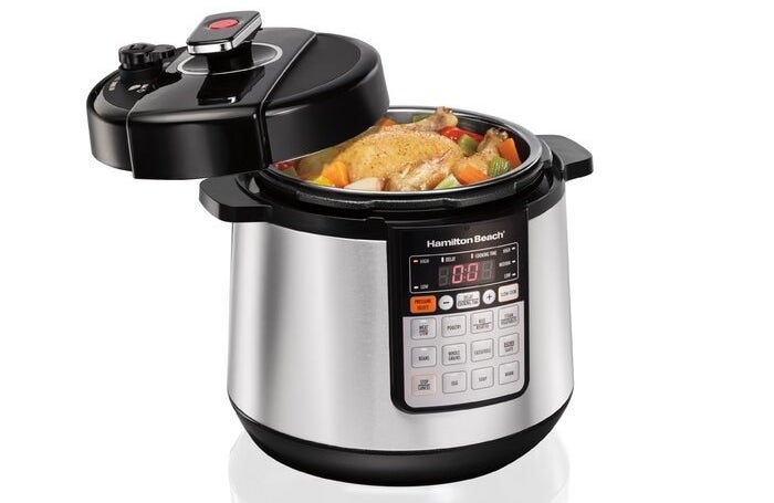 Pressure cooker with veggies inside.