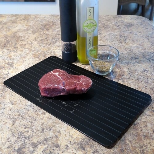 Piece of meat defrosting on the tray