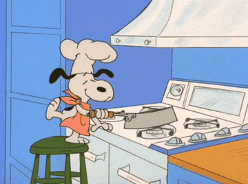 a gif of snoopy making popcorn on the stove and it going every where