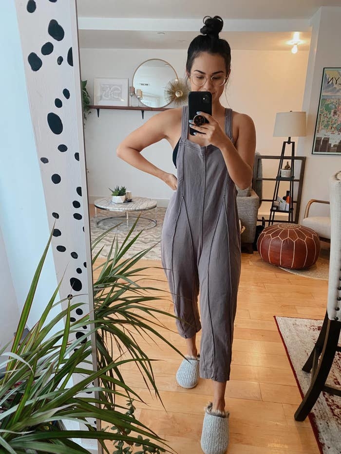 BuzzFeed Editor Kayla Suazo wearing the jumpsuit in the charcoal color