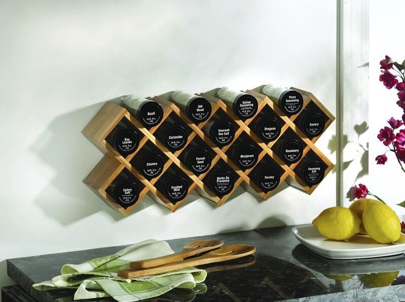 the kamenstein criss cross 18 piece spice rack mounted on a kitchen wall