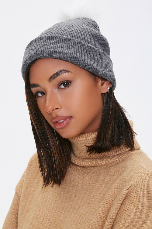 Model in gray ribbed folded over beanie with white pom pom 