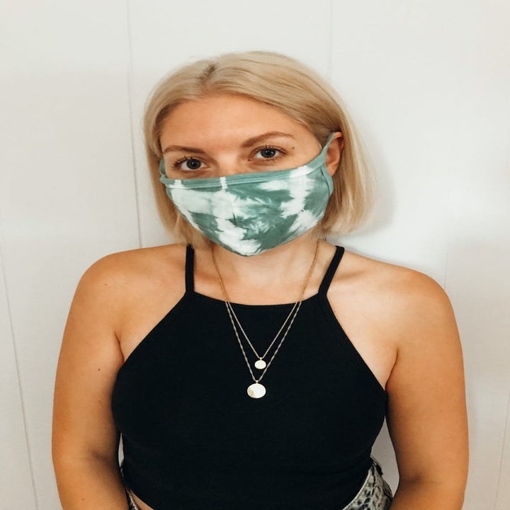 Model in white and green tie dye face mask 