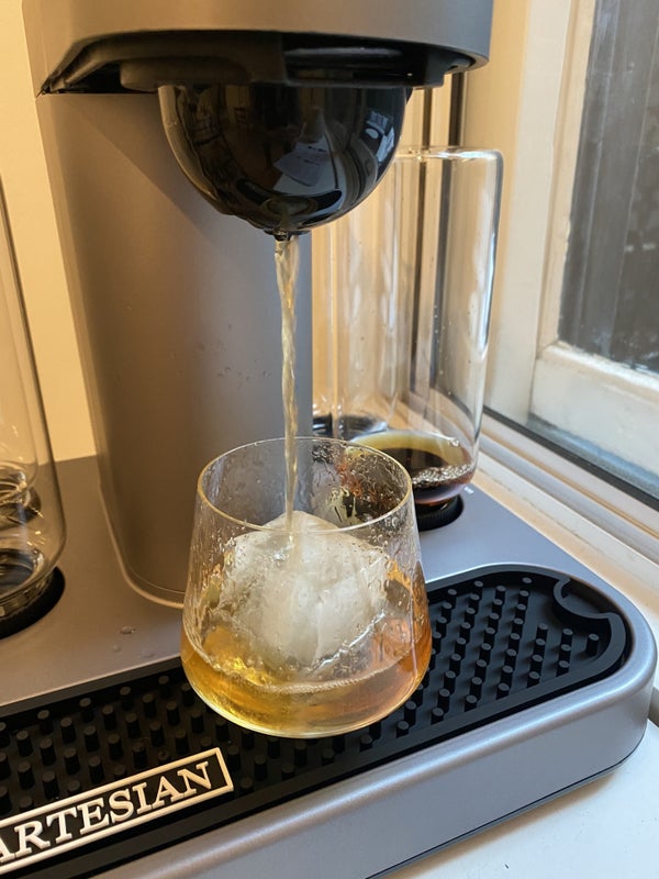 A picture from BuzzFeed Editor Hannah Loewentheil of the machine brewing a cocktail into a glass
