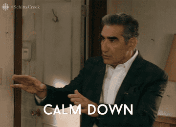 a gif of johnny rose saying &quot;breathe, calm down&quot;