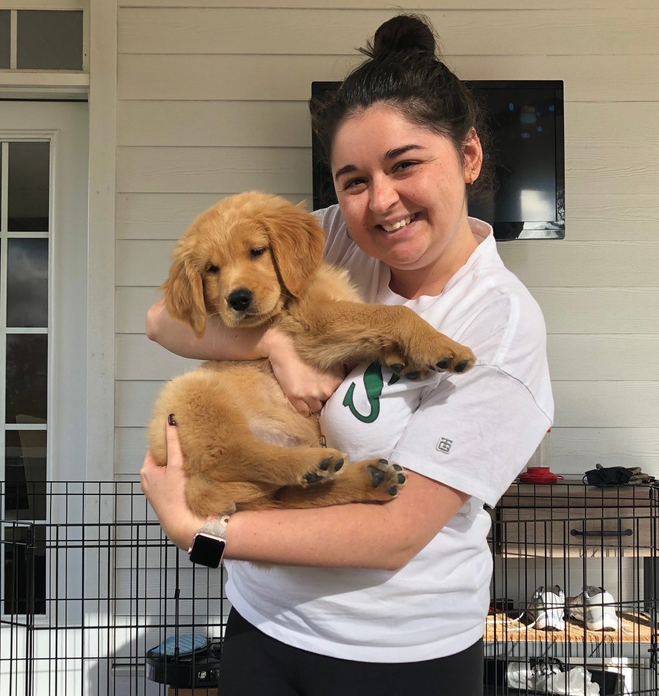 buzzfeed editor holding a golden retriever puppy