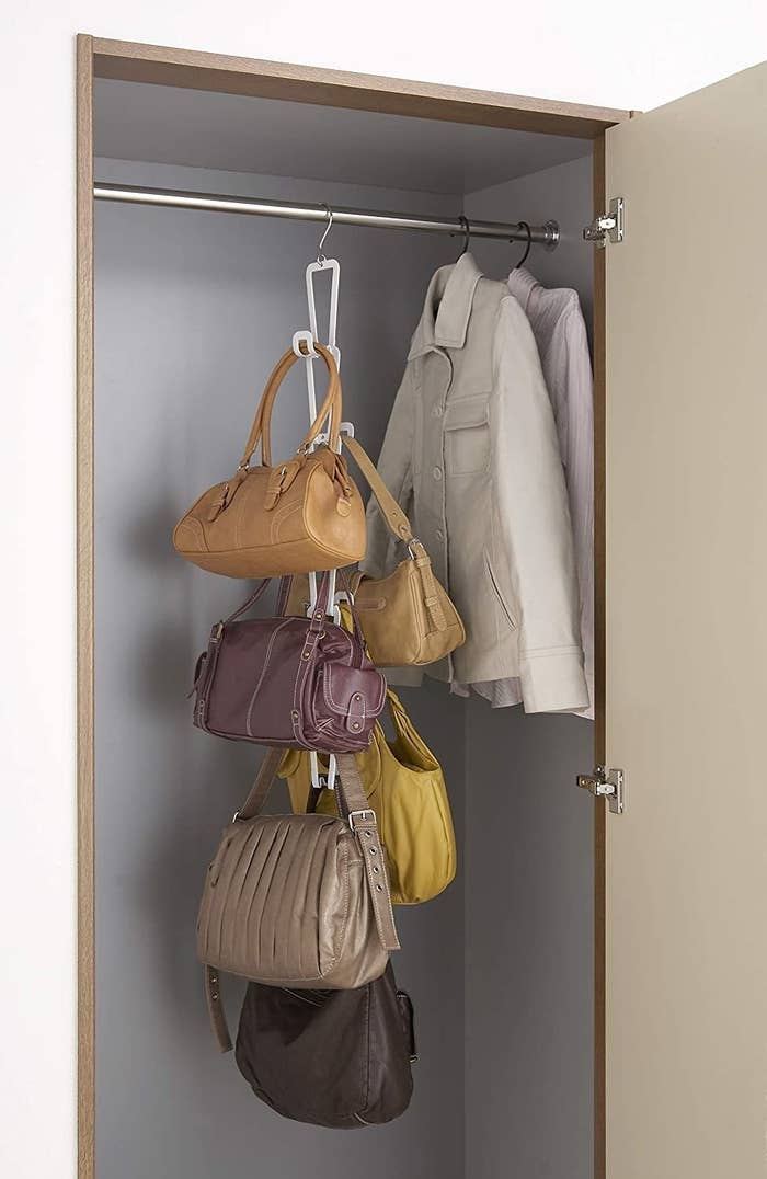 Chain-link bag holder in white attached to closet rod 