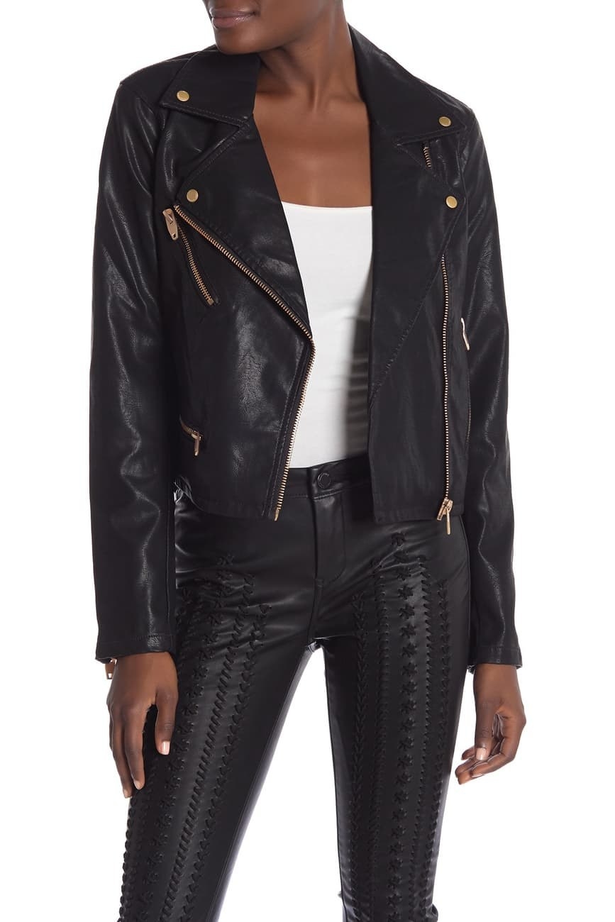 a model wearing the black faux leather jacket