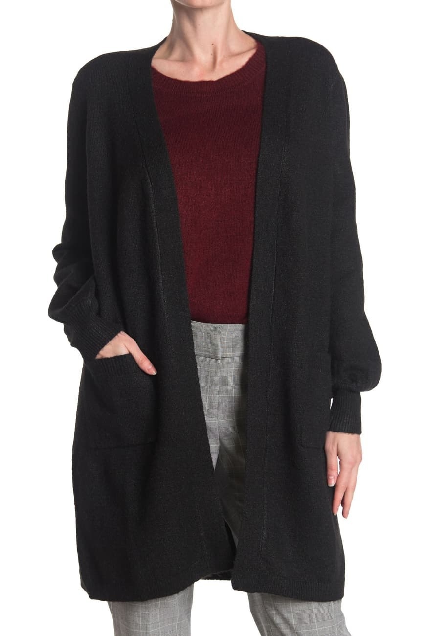 a model in the long black cardigan