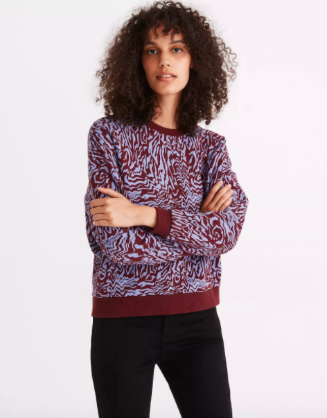 Model wearing blue and burgundy tiger print sweatshirt