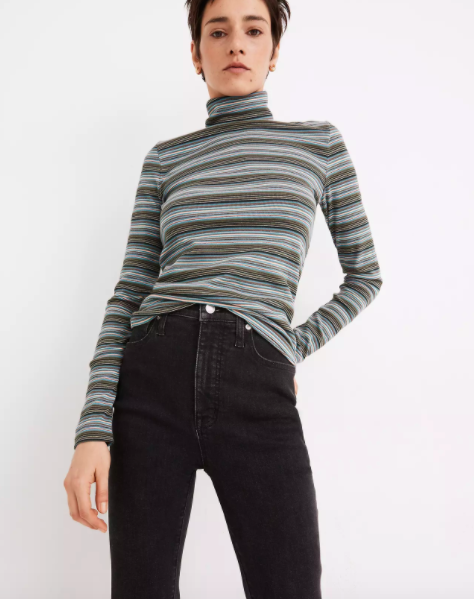 Model wearing gray striped fitted turtleneck shirt