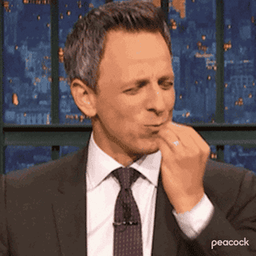 Seth Meyers performing a chef&#x27;s kiss