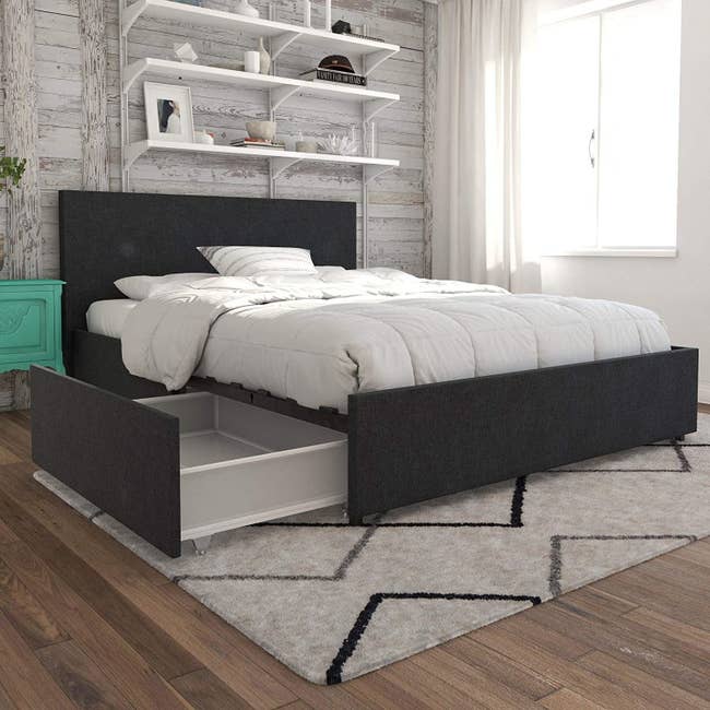the bed with drawers open under it