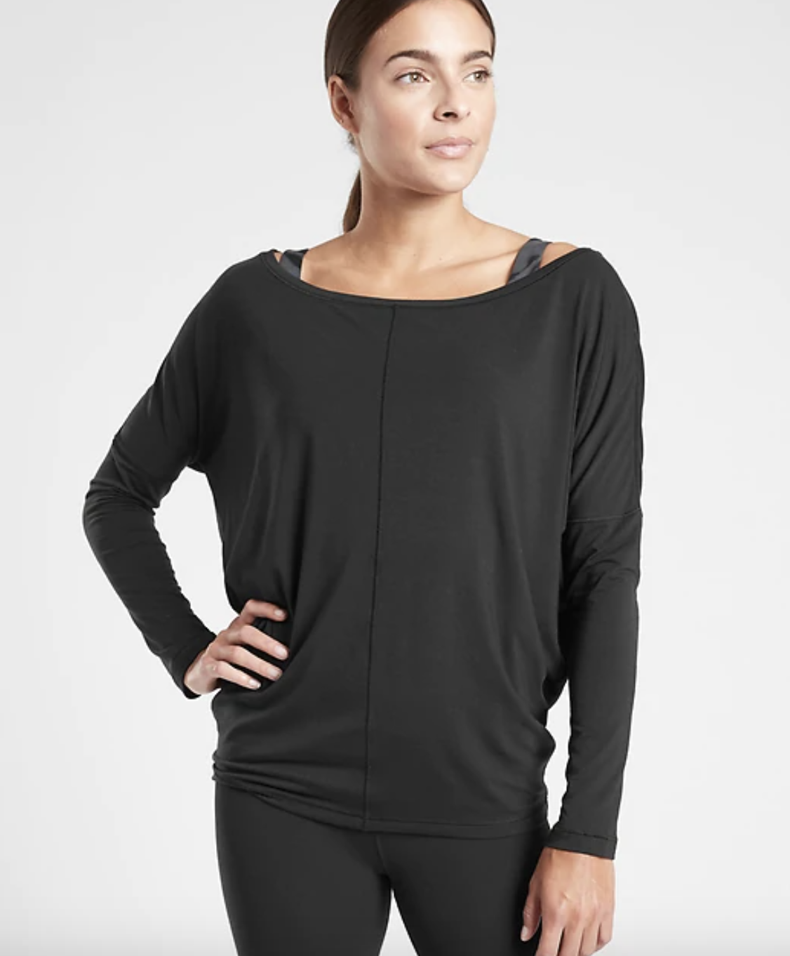 a model wears the black essence flow top