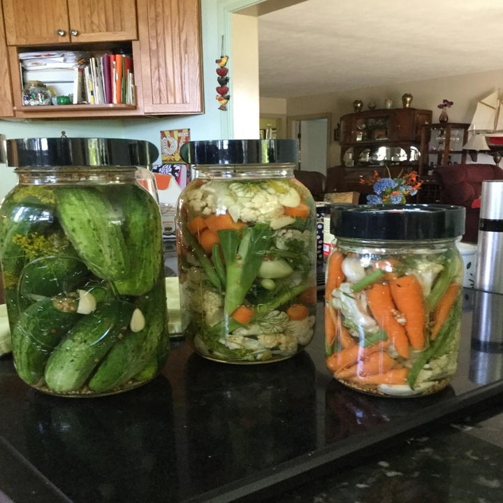 three different sized jars with different vegetables being fermented in them