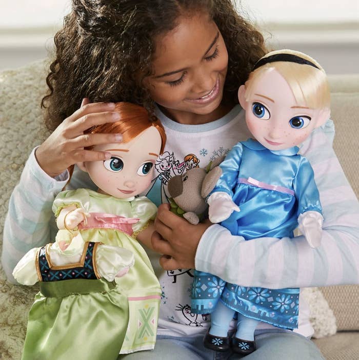 Person holding the two dolls