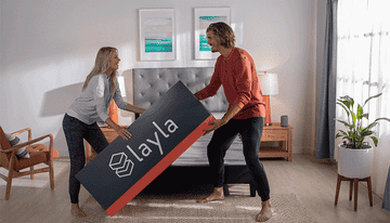 a gif of a couple unboxing their mattress
