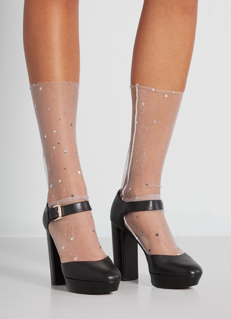 Model wearing the socks dotted with stars and black heels