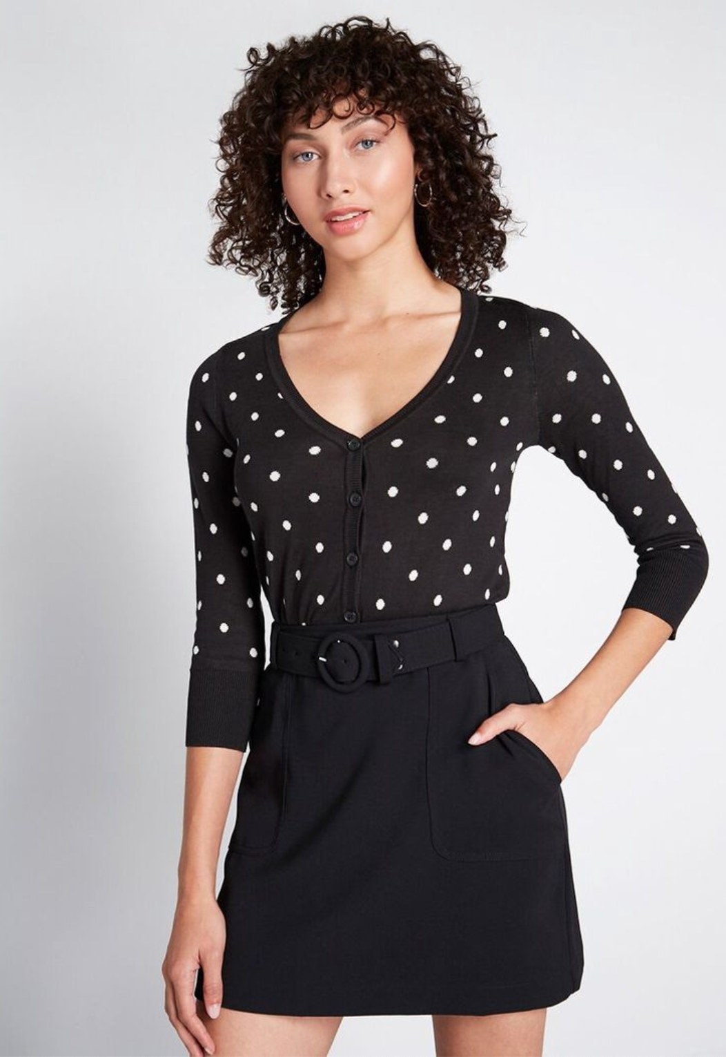 Model wearing the cardigan in black with white polka-dots