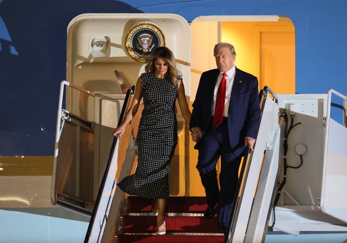 Donald and Melania Trump descend airplane stairs