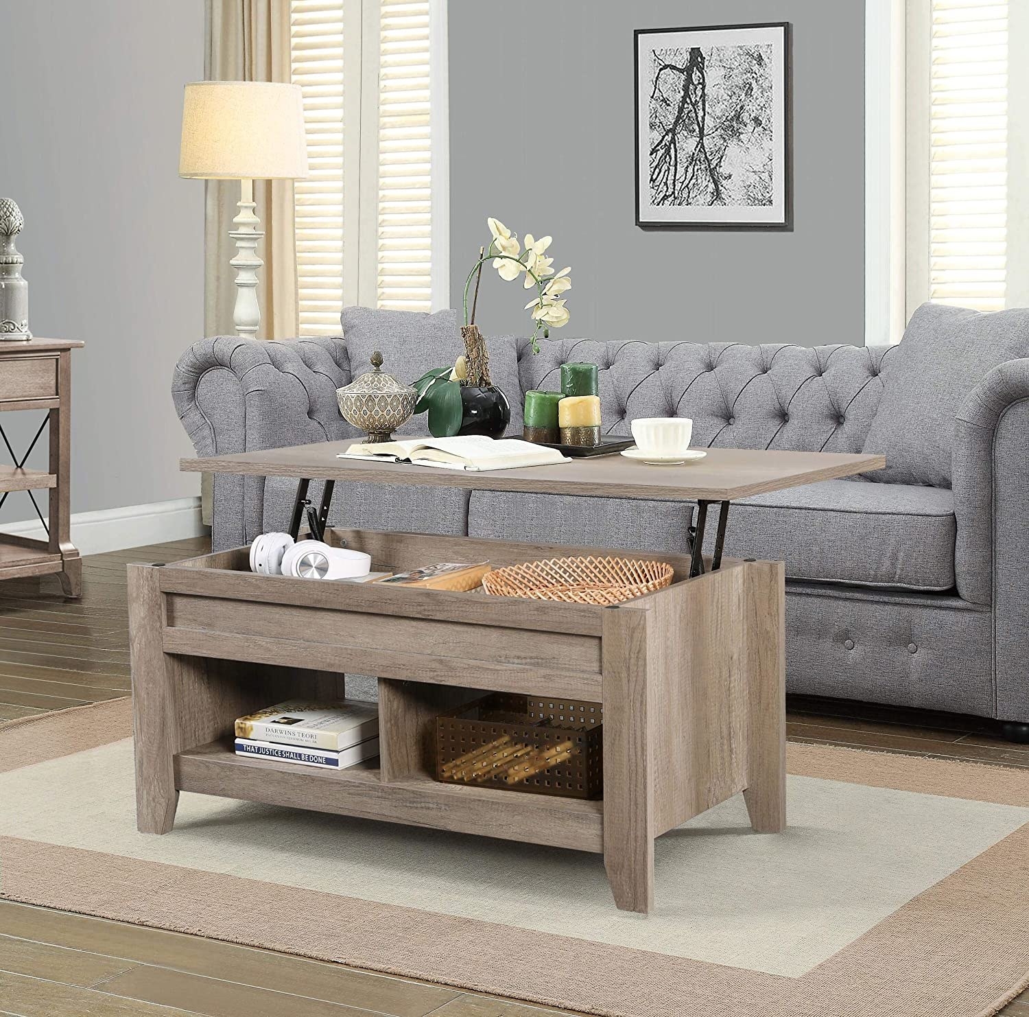 the light wood coffee table with the top lifted to show the storage inside