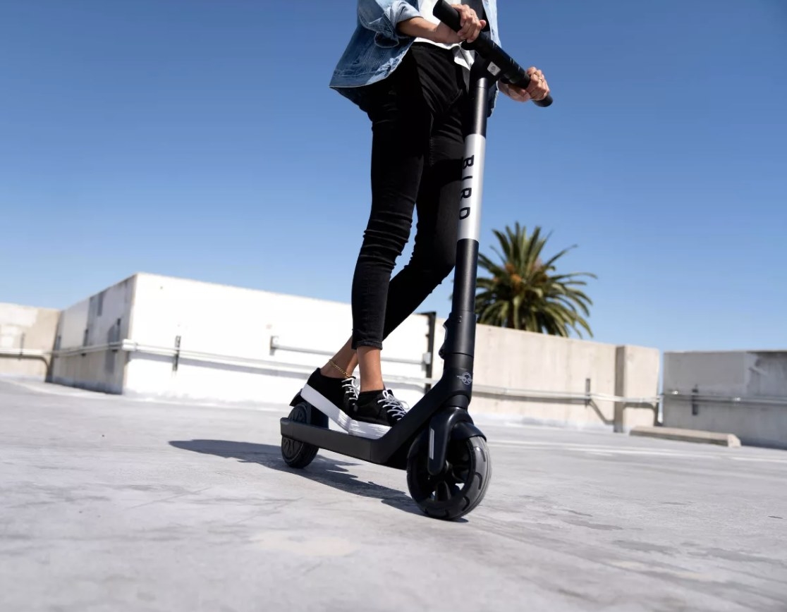 Person is riding a black electric scooter