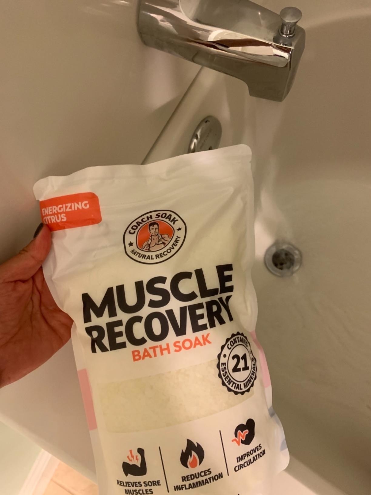 Reviewer&#x27;s photo of the citrus bath soak bag with white salt inside and black and orange details on the bag