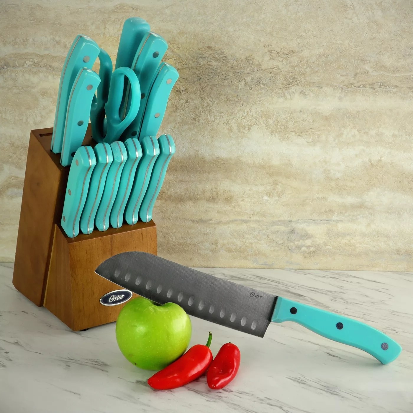 The knives in wood block with one slicing an apple