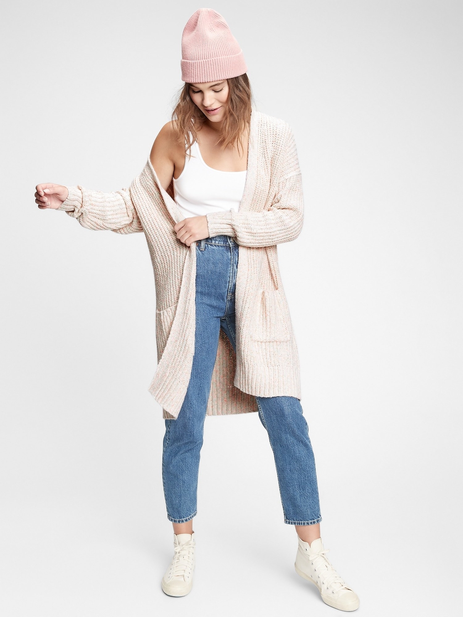 a model in an oatmeal colored long cardigan