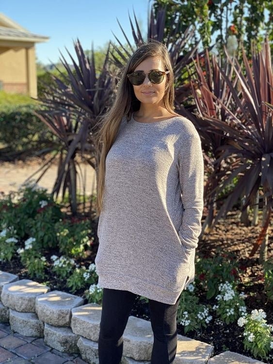 Reviewer wearing the tunic top in gray 