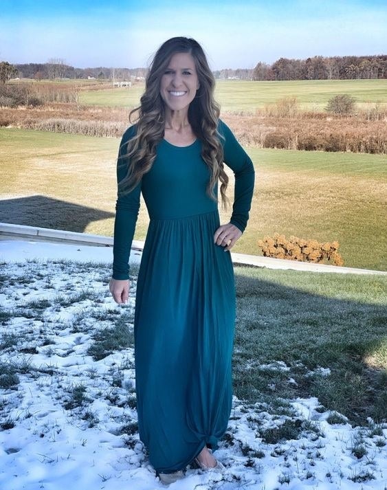 Reviewer wearing the long-sleeve maxi dress in green 
