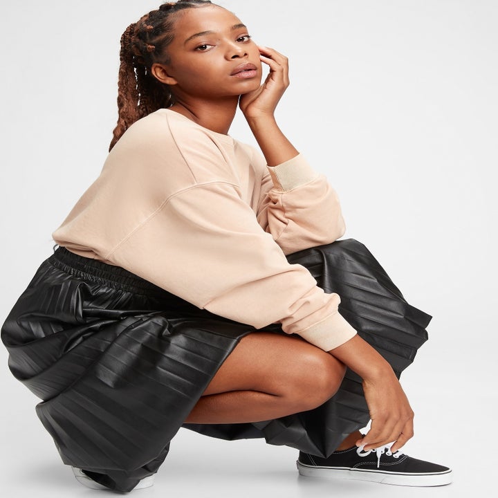 a model squatting down in the skirt