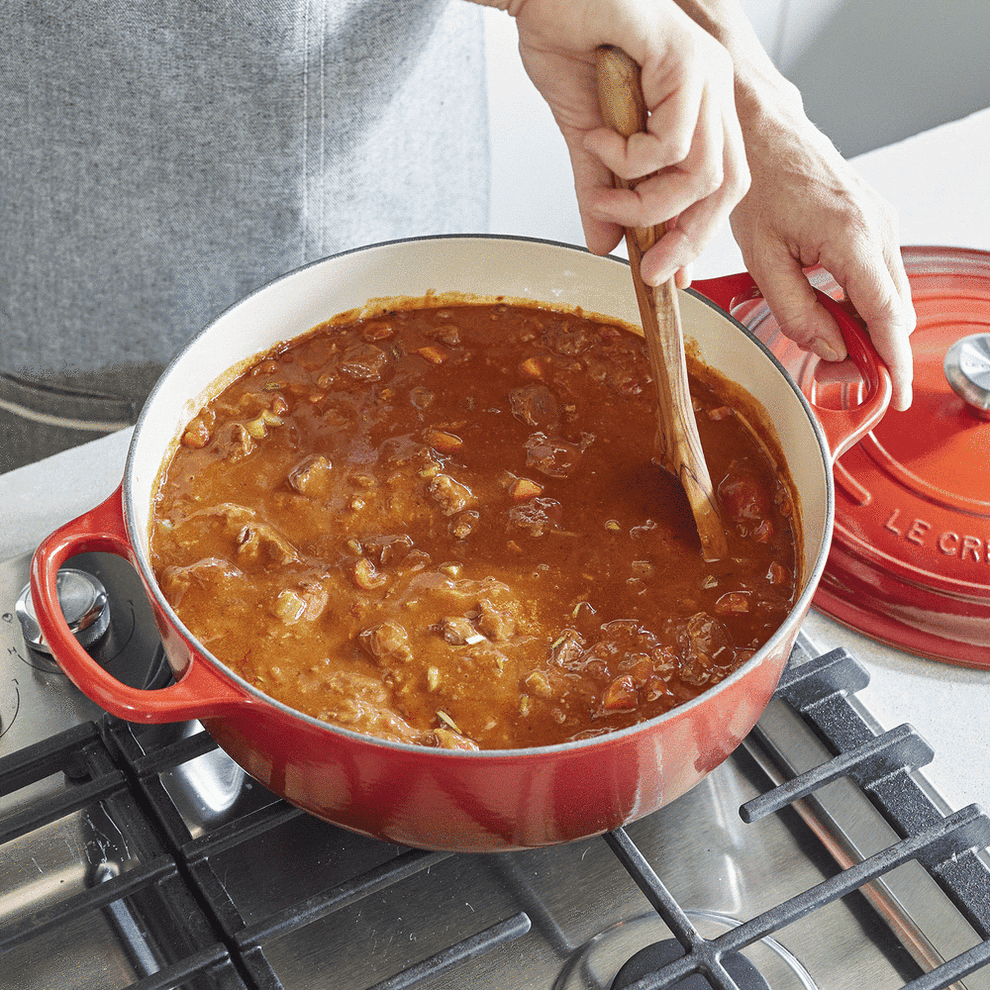 gif of model stirring a stew in the Dutch Oven 