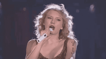a gif of taylor swift singing sparks fly from an official speak now tour video