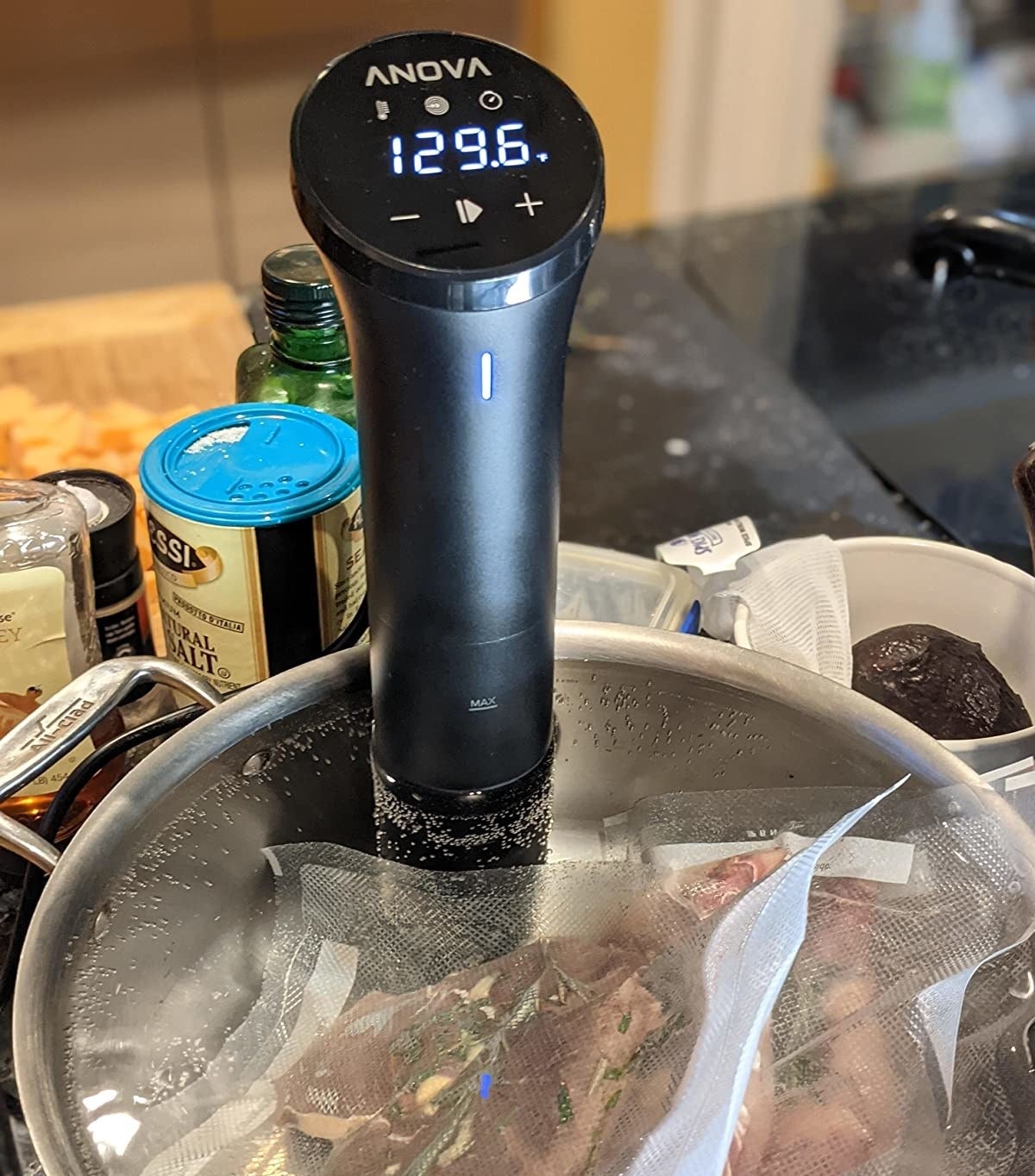 reviewer photo showing sous vide attached to a pot with two steaks cooking in it 