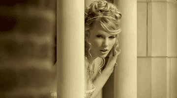 a gif of taylor swift in the love story music video